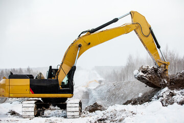 Excavator at a construction site digs a trench for laying a gas pipe in siberia 