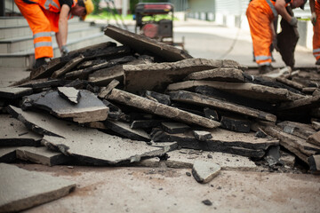 Asphalt repair. Removal of road surface. Workers break the asphalt with jackhammers. Construction of a pedestrian zone in the city.