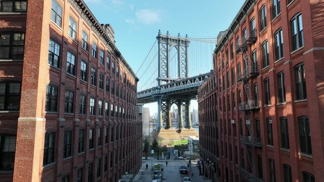 moving toward Empire State Building framed within Manhattan Bridge from Brooklyn New York City