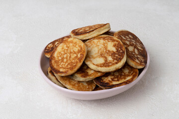 Close-up of homemade pancakes on a light table, home cooking, breakfast