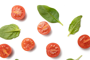 Beautiful border made of fresh cherry tomatoes with spinach leaves, Vegan diet food isolated on white, vegetable pattern, top view