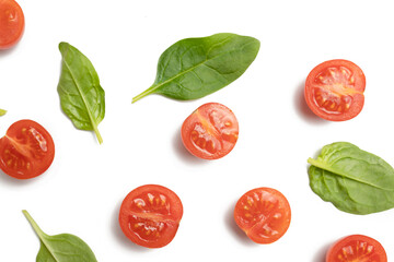 Beautiful border made of fresh cherry tomatoes with spinach leaves, Vegan diet food isolated on white, vegetable pattern, top view
