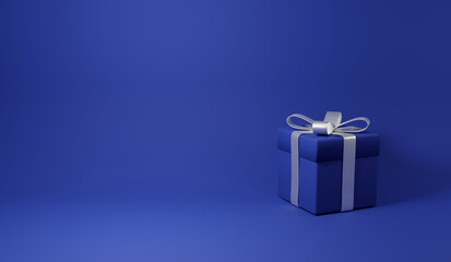 青い背景に青い箱のプレゼントボックス。銀色のリボン。