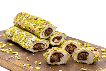 Turkish Delight with Pistachio. Turkish delight with chocolate filling, isolated on a white background. Traditional Turkish cuisine delicacies. close up