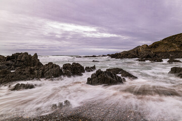 The rocks on this North Devon Beach are lapped by the sea on a cold November day.