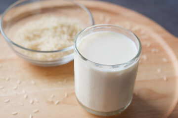 Obraz na płótnie Canvas glass of milk and rice on a table, non dairy milk concept 