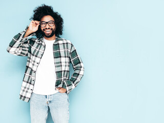 Handsome confident hipster  model.Sexy unshaven Arabian man dressed in summer shirt and jeans...