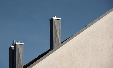 Fototapeta na wymiar chimneys on a roof covered with metal sheets