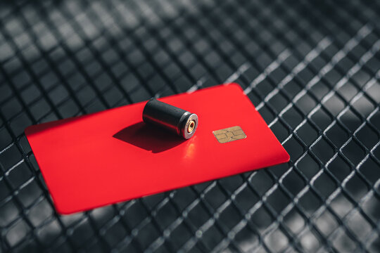 bullet case on a credit card. concept - weapons and business.