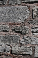 Background, texture of natural stone. Fragment of an old wall made of large stone blocks.