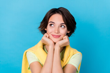 Photo of adorable sweet woman wear green t-shirt arms cheeks looking empty space isolated blue color background