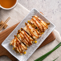 Delicious Taiwanese omelette, egg pancake roll with ham and corn kernels.