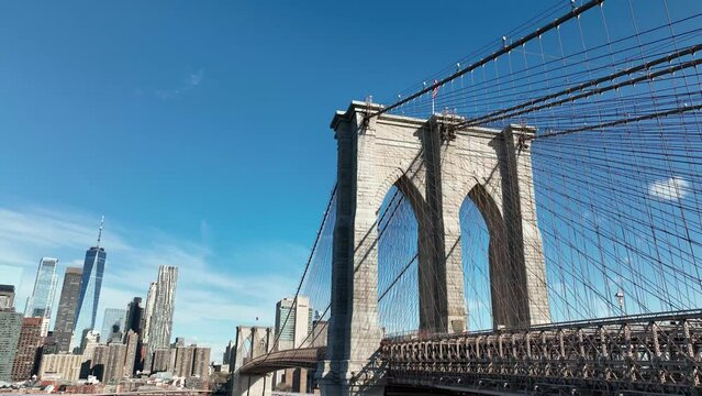 Rising Aerial Brooklyn Bridge From Low Upward View American Flag Manhattan Skyline New York City