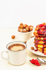 Traditional homemade breakfast with pancakes and coffee. Raspberry, hazelnut, sweet jam