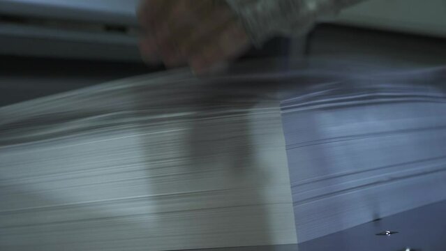 Printed sheets of paper are served in the printing press offset printing