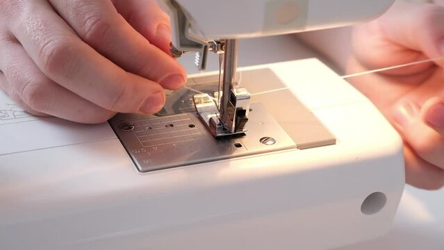A man sews clothes on a sewing machine. Hobbies, needlework, creativity.