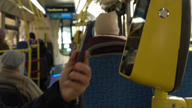 close up male hand is paying transport ticket with mobile phone.