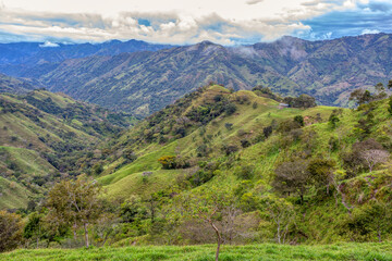 Fototapeta na wymiar Beautiful view on the hills and forest surrounding Los Quetzales national park, beautiful Costa Rica Wilderness landscape