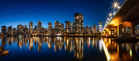 Fototapeta na wymiar Cambie Bridge in False Creek with modern city buildings at night after sunset. Downtown Vancouver Cityscape, British Columbia, Canada. Panorama