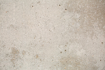 Heterogeneous concrete background of gray-beige color with inclusions, close-up