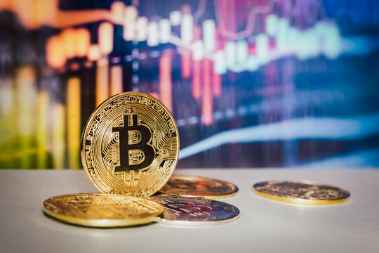 Gold bitcoin with trading graph chart in background Virtual cryptocurrency concept.