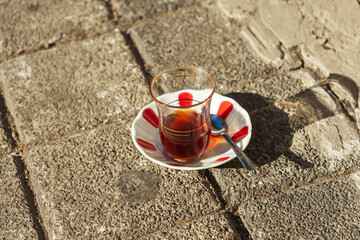 Turkish tea in a national cup. Tea in Turkey on the street on the ground. Traditional Turkish cup...