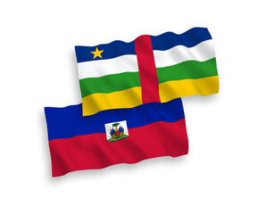 National vector fabric wave flags of Central African Republic and Republic of Haiti isolated on white background. 1 to 2 proportion.