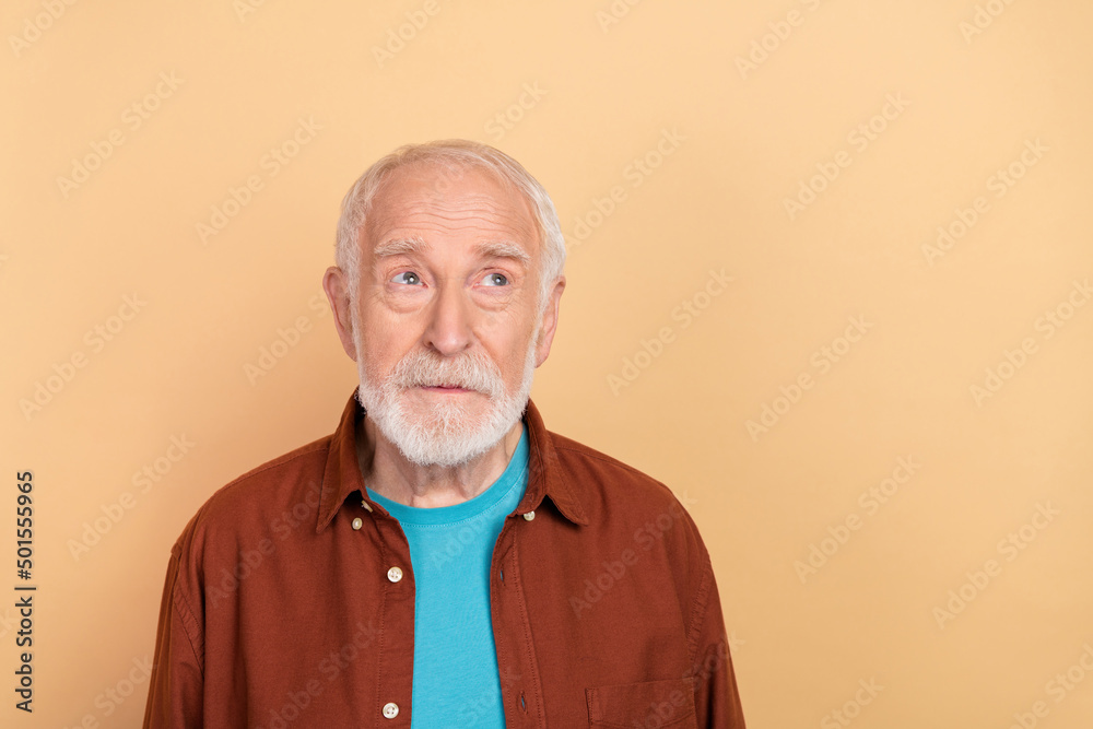 Wall mural photo of strict old grey hairdo man look promo wear brown shirt isolated on beige color background