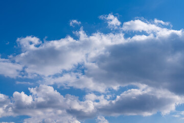 White clouds in the blue sky. Clear heaven on a clear, fine summer day