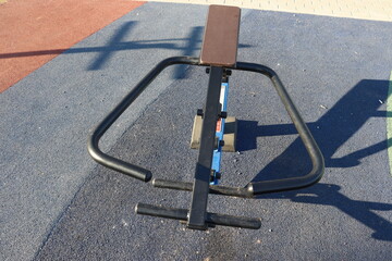 trainers and horizontal bars in city yard
