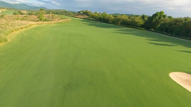 FPV drone flight over lush green fairway of golf course in the Caribbean