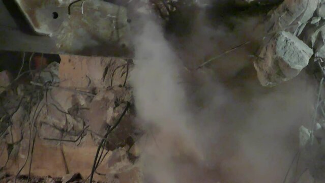 Heavy Demolition Machine Destroying a Building Complex - Close up Shot