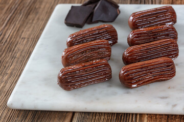 Chocolate Tulumba dessert served on the marble 