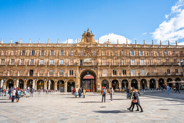 Fototapeta na wymiar Salamanca, Spain - november 6 2022 - Tourist and locals crossing the Plaza Mayor (Major Square) in the center of town