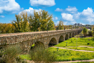 Fototapeta na wymiar Salamanca, Spain - november 6 2022 - tourists and locals visiting the prehistoric roman bridge (Puente Romano) at the edge of town