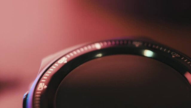 The dial of a wrist watch smoothly rotating in macro