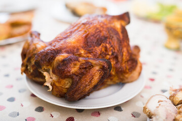 ruddy chicken fried whole on a plate on the festive table
