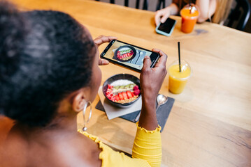 Woman taking picture of food with smartphone