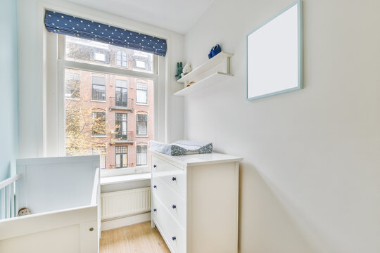 Interior of bedroom with baby crib in daytime