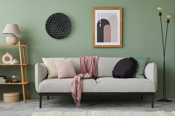 Stylish composition of modern living room interior. Mock up poster frame, wooden shelf, modern sofa and creative personal accessories. Eucalyptus wall. Home staging. Template. Copy space.