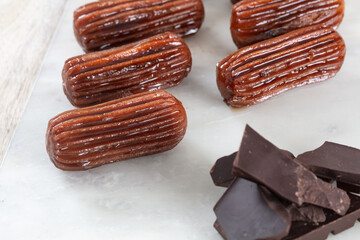 Chocolate Tulumba dessert served on the marble 