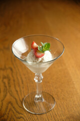 Ice cream in a glass martinique with mint leaf and strawberries