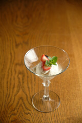Ice cream in a glass martinique with mint leaf and strawberries