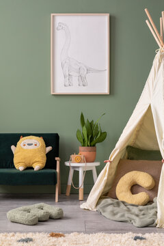 Stylish composition of cozy child room interior design with green wall witk poster and bottle green sofa. Stool with plant and orange accessories. Mock up. Bottle green sofa, posters, plush pillow.