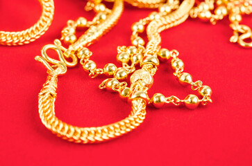 The gold necklace on red Velvet fabric.