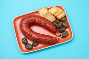 typical portuguese smoked sausage, olives and toasts