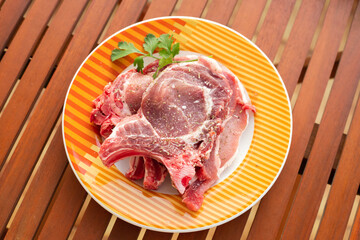 raw meat with marinate and herbs on dish