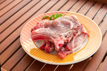 raw meat with marinate and herbs on dish