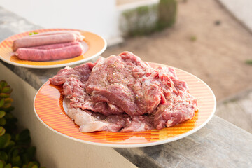 raw meat with marinate and herbs on dish