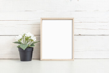 Mockup of a vertical wooden frame on a light background